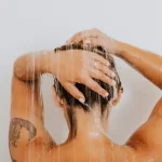 Woman showering as part of daily wellness routine with Duo Senses CBD personal care products