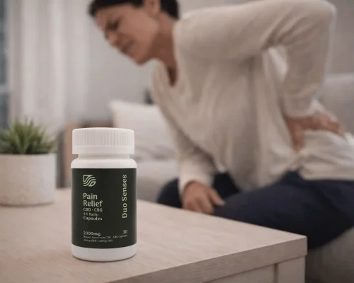 Person with back pain holding Duo Senses CBD CBG pain relief capsules for inflammation and discomfort